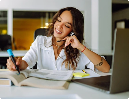 Virtual contractor assistant managing paperwork and schedules while wearing a headset at a modern office desk